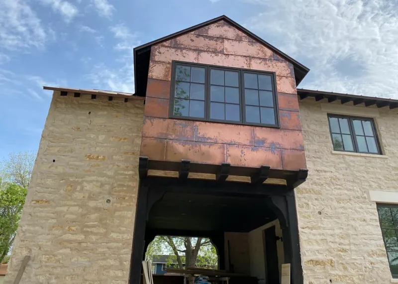 Copper metal panel facade on a stone building for Skylight Installation in Lindstrom