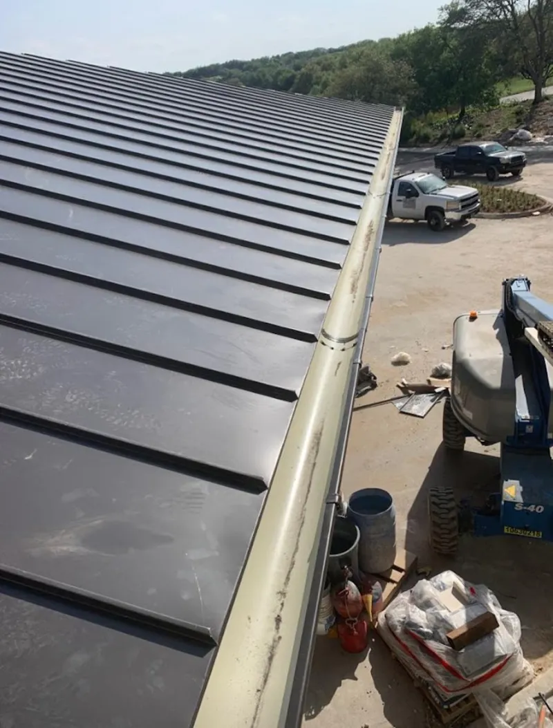 Standing seam panel and gutter detail on a metal roofing jobsite in Lindstrom